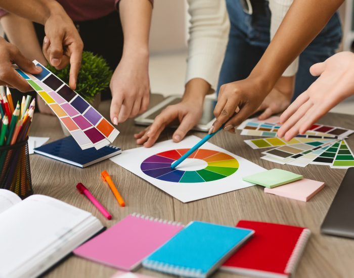 Group of young graphic designers choosing color swatch samples